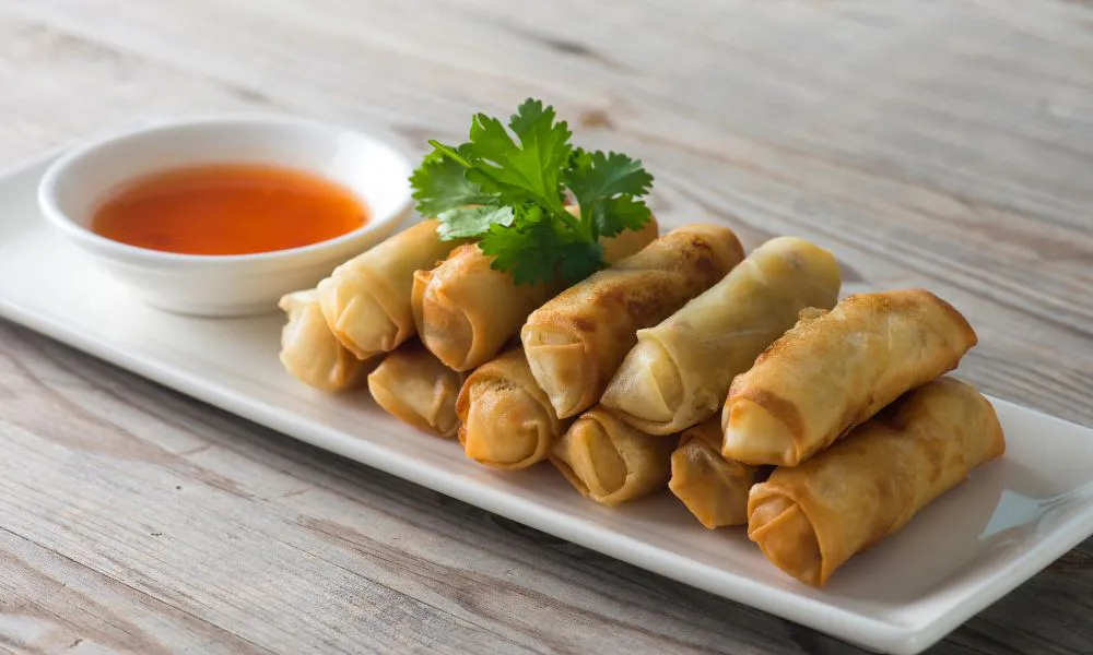 Golden fried spring rolls with sweet chili sauce and cilantro garnish at Tokyo Express, a Japanese Restaurant in Greenville