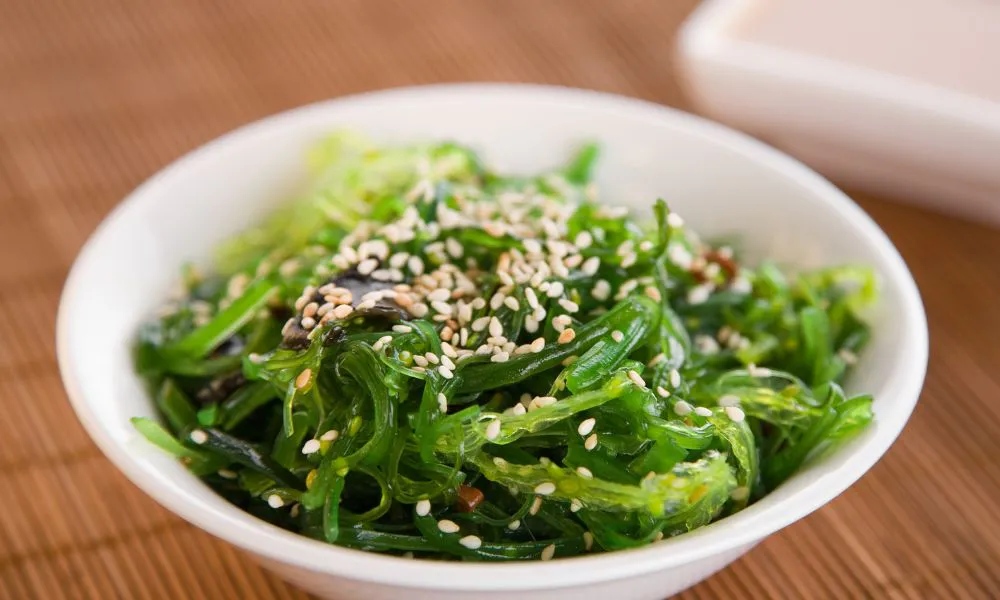 Chuka wakame seaweed salad topped with sesame seeds in a white bowl at Tokyo Express, a Japanese Restaurant in Greenville