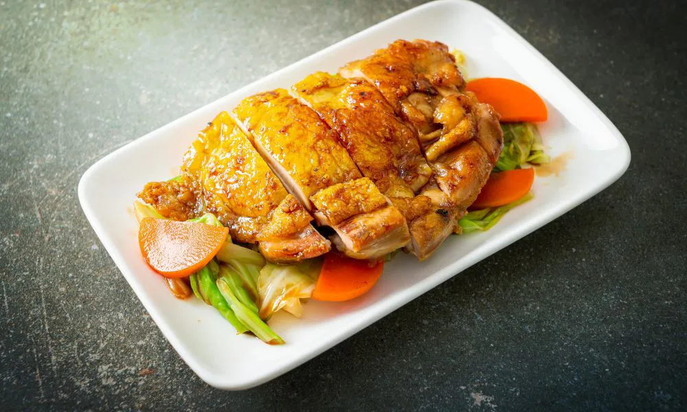 Grilled teriyaki chicken slices with vegetables on a white plate at Tokyo Express, a Japanese Restaurant in Greenville